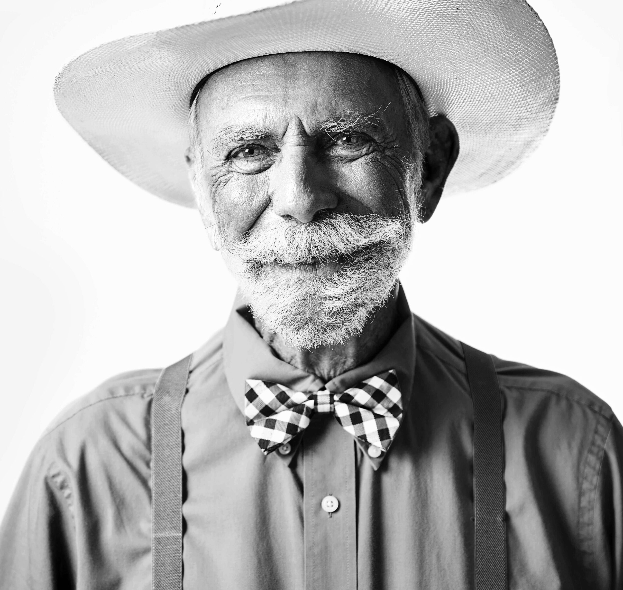 photo of older-adult-cowboy-in-suspenders-hat-and-twinkling-eyes